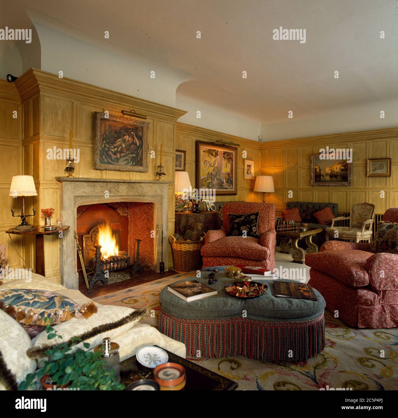 Woode panelled traditional livingroom with open fire Stock Photo - Alamy