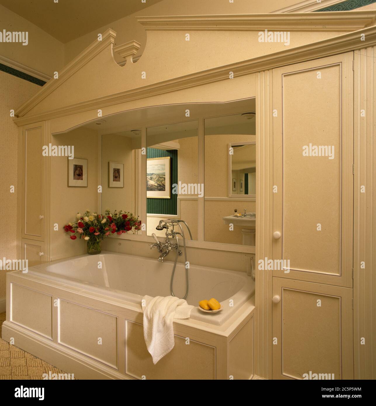 Bathroom with built in bath backed with mirror Stock Photo Alamy