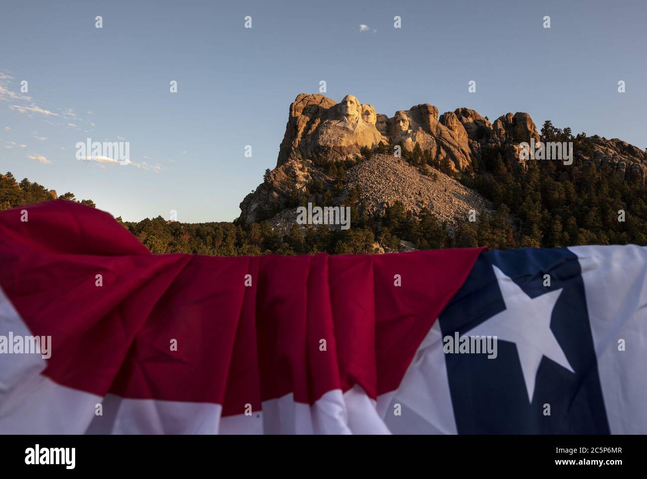 Keystone, United States. 04th July, 2020. The first light of the day hits Mt.Rushmore National Monument in Keystone, South Dakota on Saturday, July 4, 2020. President Donald Trump condemned the toppling of Confederate statues and announced an executive order to establish a statuary garden during his appearance at Mount Rushmore on the eve of the Fourth of July. Photo by Bob Strong/UPI Credit: UPI/Alamy Live News Stock Photo