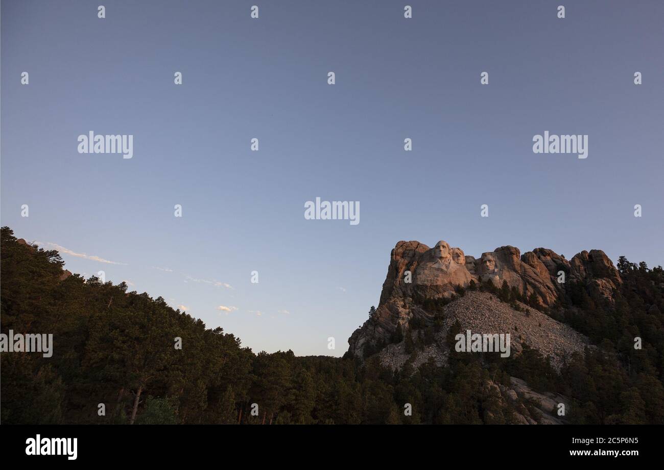 Keystone, United States. 04th July, 2020. The first light of dawn hits Mt.Rushmore National Monument in Keystone, South Dakota on Saturday, July 4, 2020. President Donald Trump condemned the toppling of Confederate statues and announced an executive order to establish a statuary garden during his appearance at Mount Rushmore on the eve of the Fourth of July. Photo by Bob Strong/UPI Credit: UPI/Alamy Live News Stock Photo