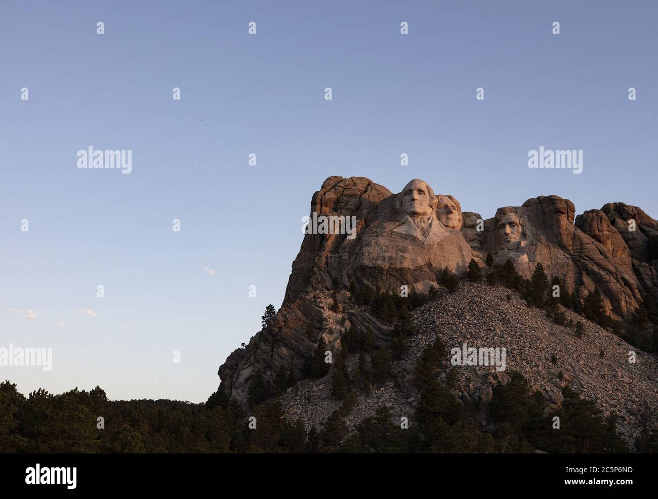 Keystone, United States. 04th July, 2020. The first light of dawn hits Mt.Rushmore National Monument in Keystone, South Dakota on Saturday, July 4, 2020. President Donald Trump condemned the toppling of Confederate statues and announced an executive order to establish a statuary garden during his appearance at Mount Rushmore on the eve of the Fourth of July. Photo by Bob Strong/UPI Credit: UPI/Alamy Live News Stock Photo