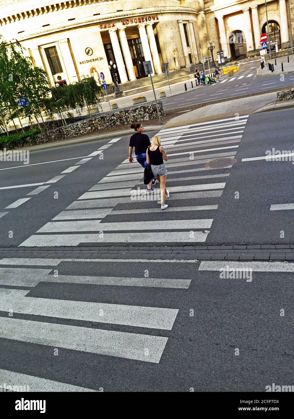 The white piano keys are painted for pedestrians as a crossing road beside Palace of Culture & Science in Warsaw. Chopin and musical background. Stock Photo