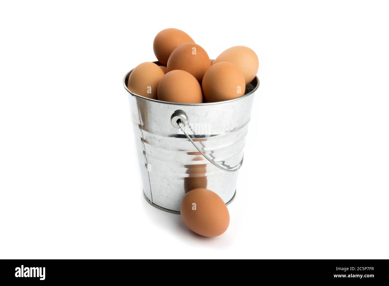 a metal bucket of eggs fresh from the chicken coop isolated on white Stock Photo