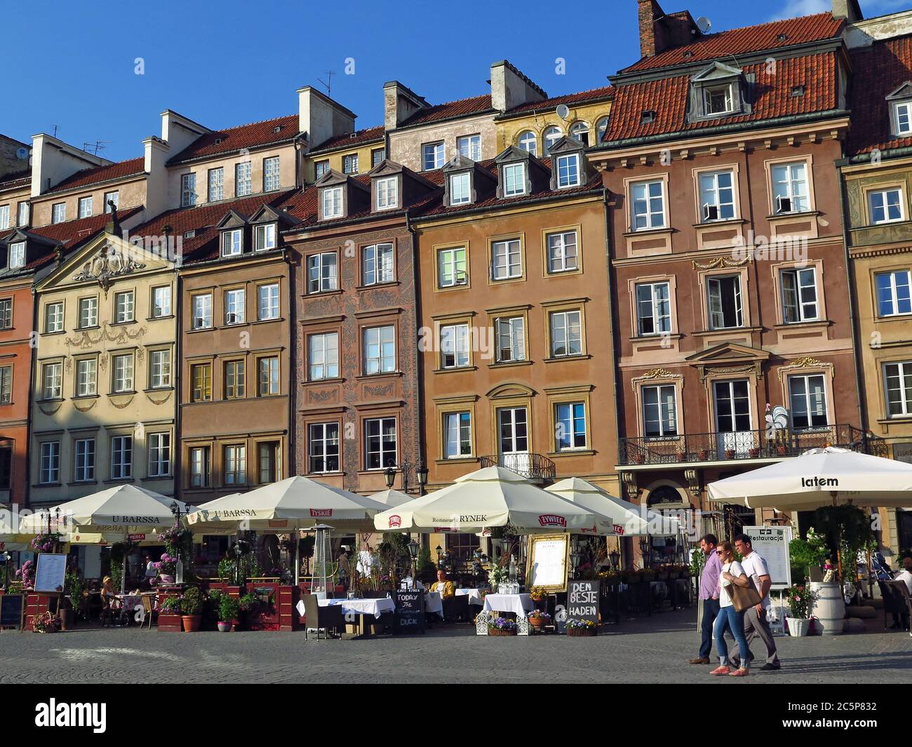 Restaurant on Warsaw's Old Town Square, surrounded by houses rebuilt after World War II. The area belongs to UNESCO heritages. Stock Photo