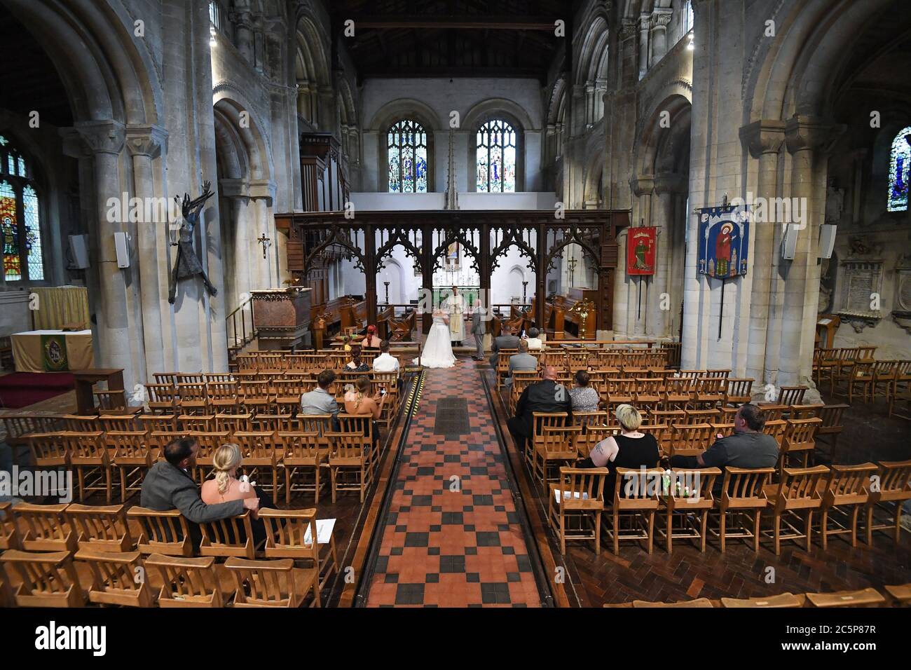 The wedding of Tina-Lynn Birch and Billy Bryant inside the Priory Church of St Peter, Dunstable, Bedfordshire, as weddings are once again permitted to take place in England, with ceremonies capped at a maximum of 30 guests. Stock Photo