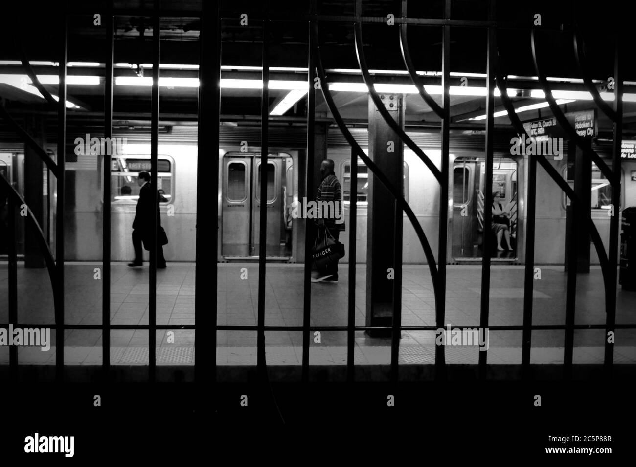 New York City as it reopens and people practice social distance  in the subway in the streets and in the train station Stock Photo