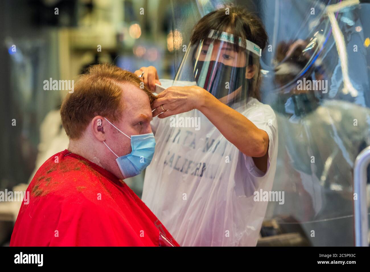 London, UK. 04th July, 2020. Getting a haircut in Chinatown Wider reopening of bars and