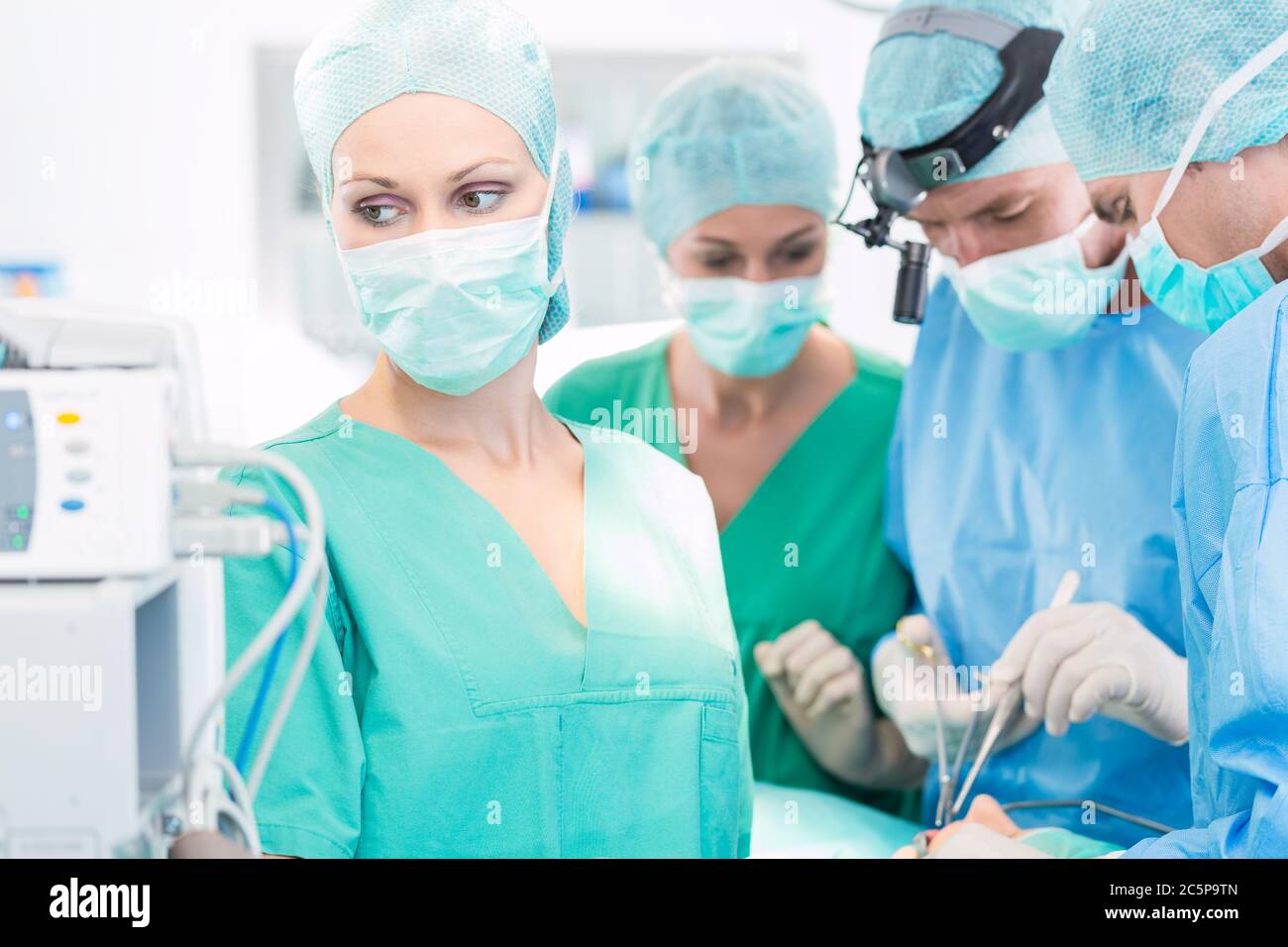 Surgeon doctors working in operation theater Stock Photo