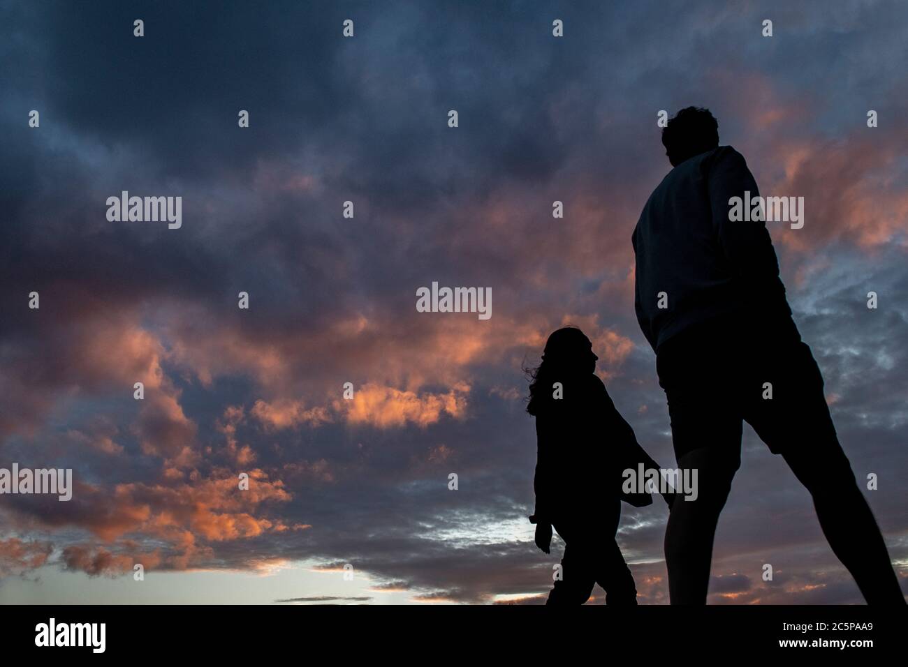 A couple take a walk in a London park enjoying the sunset Stock Photo ...