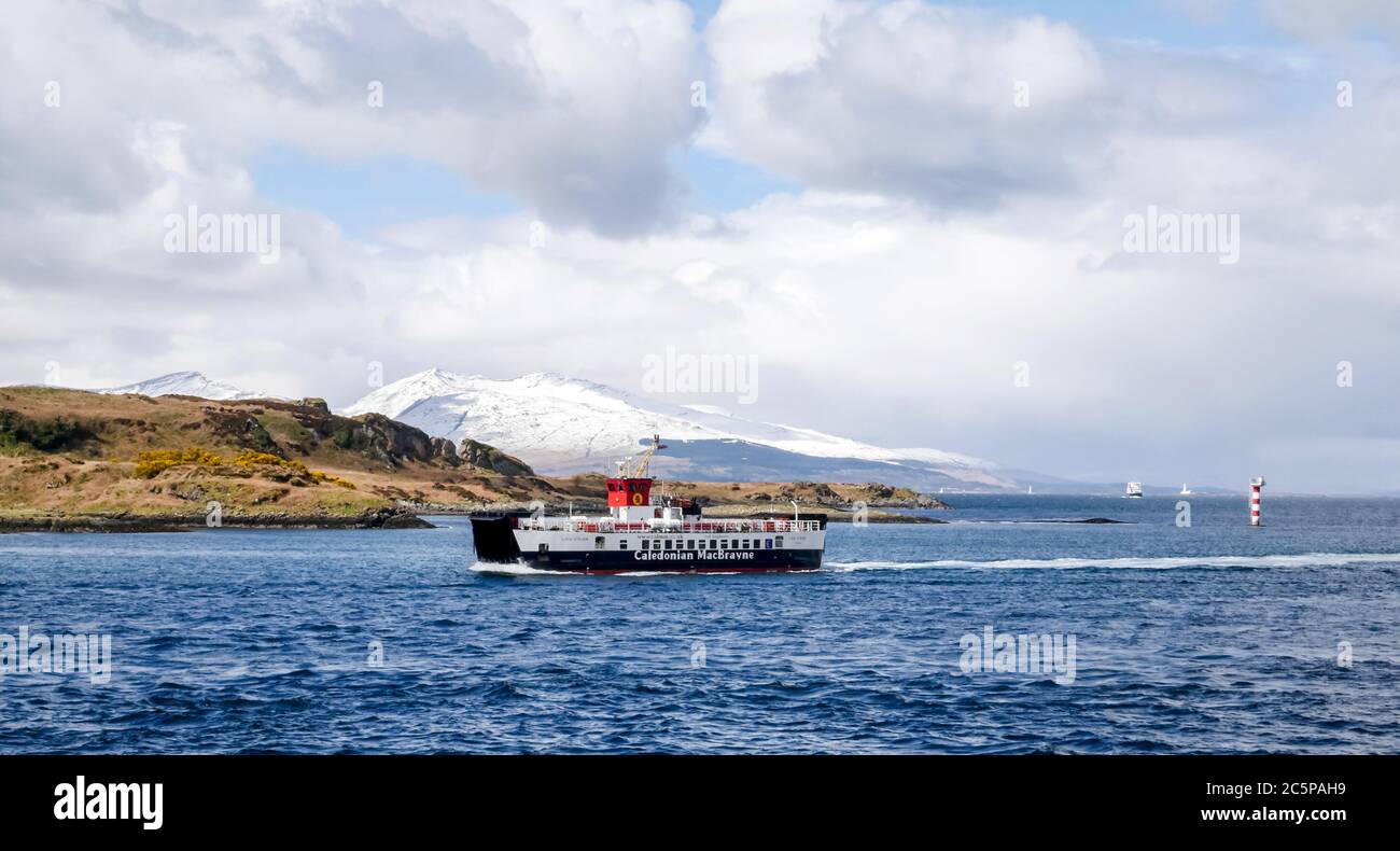 Caledonian MacBrayne ferry crossing to Isle of Mull with snow covered mountains in the distance, Sound of Mull, Inner Hebrides, Scotland, UK Stock Photo