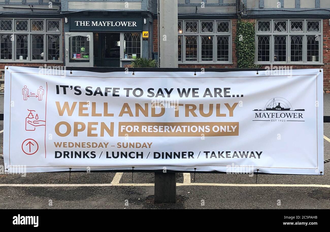 Sign outside The Mayflower pub, Lymington, Hampshire, announces limited reopening as coronavirus lockdown restrictions are eased across England. Stock Photo