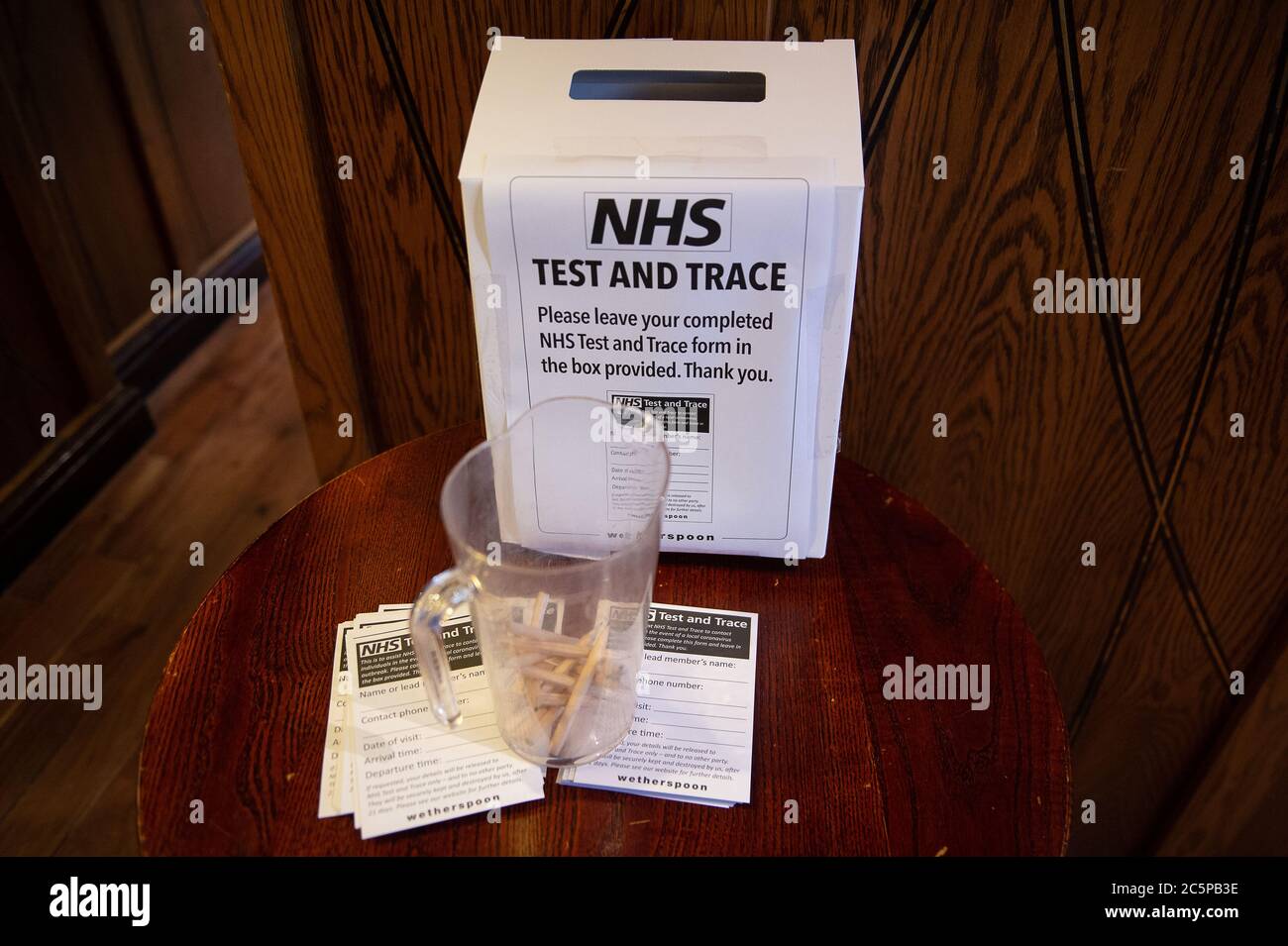 Windsor, Berkshire, UK. 4th July, 2020. NHS Test and Trace forms for people to fill in before they leave the Wetherspoon King and Castle pub in Windsor, Berkshire. Today the pub opened for the first time since the Coronavirus lockdown in March. Credit: Maureen McLean/Alamy Live News Stock Photo