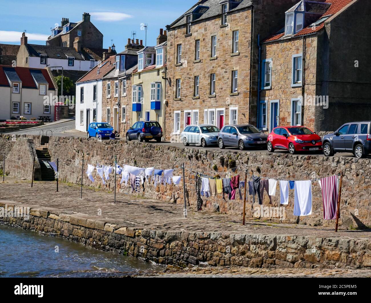 Washing hanging to dry on communal clotheslines in harbour, Anstruther, Fife, Scotland, UK Stock Photo