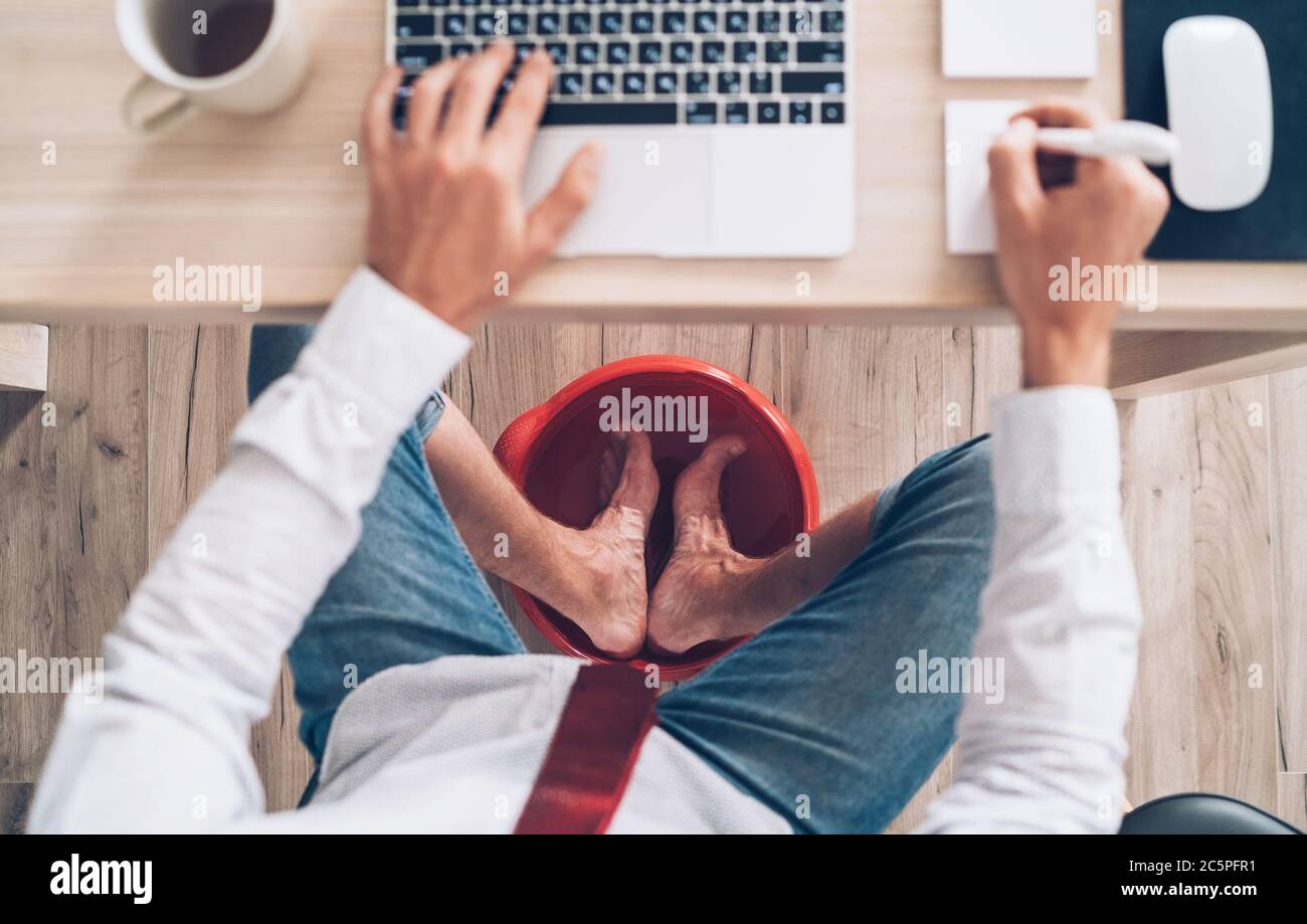 Comic modern office table top view shot. Businessman typing on laptop
