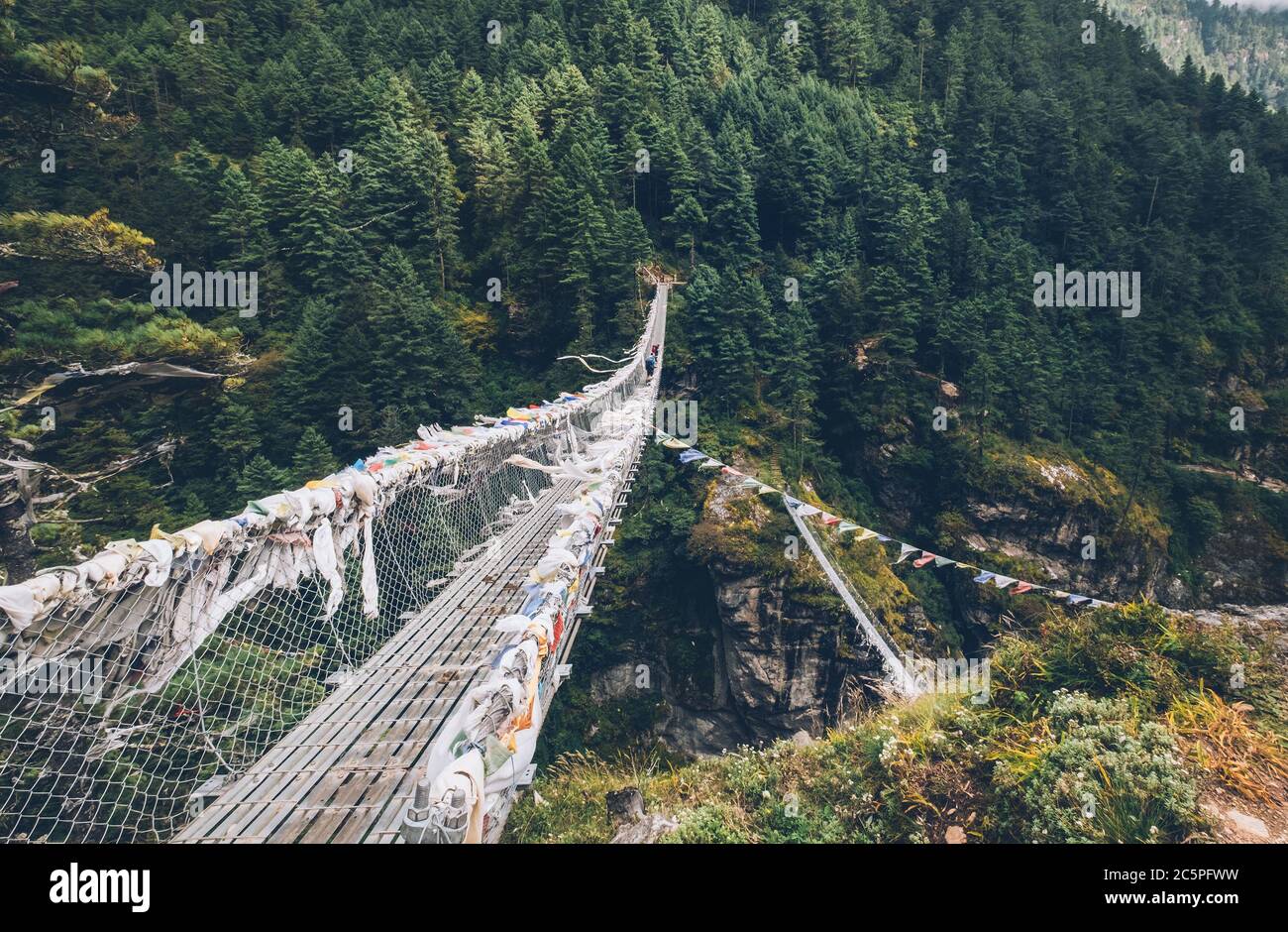 Suspension Bridge decorated with multicolored Tibetan Prayer flags