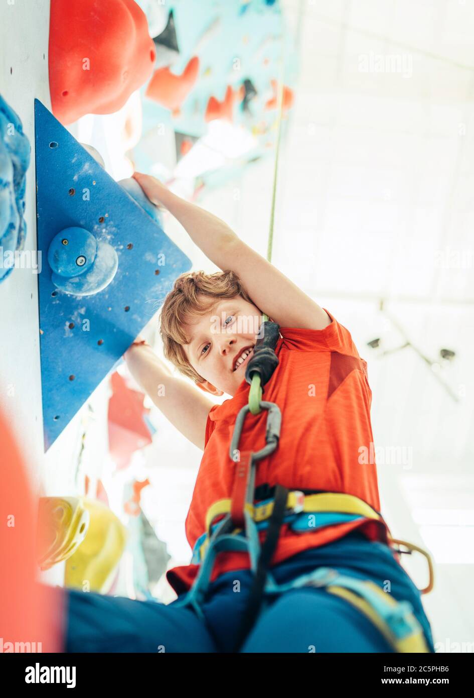 Boy climbing wall harness hi-res stock photography and images - Alamy
