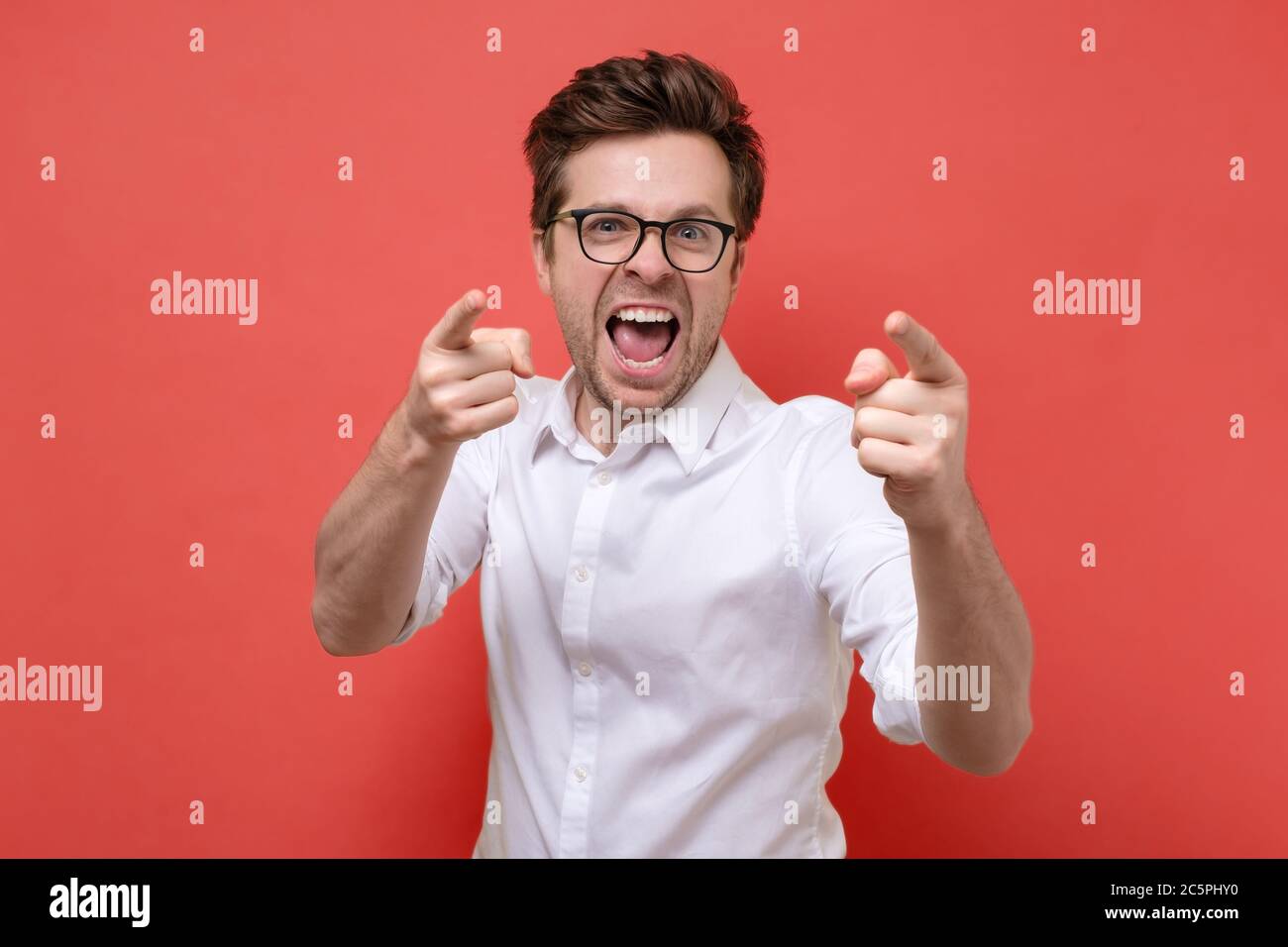 smiling man pointing fingers at camera, picking you Stock Photo