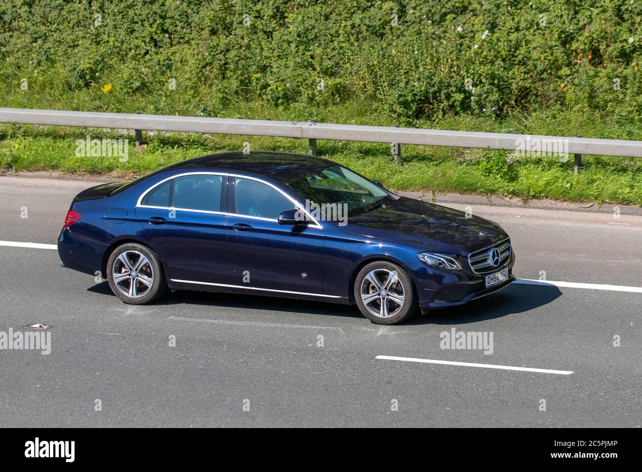 2017 blue Mercedes-Benz E 220 D SE Auto; Vehicular traffic moving vehicles, cars driving vehicle on UK roads, motors, motoring on the M6 motorway highway network. Stock Photo