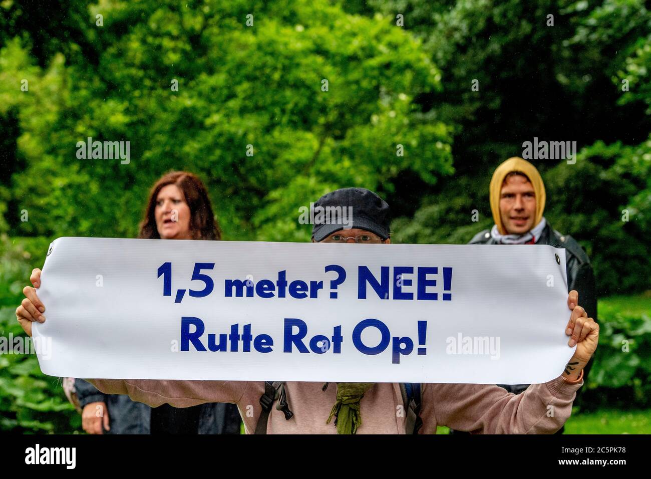 A protester is seen displaying a banner saying that 1.5 social distance measure is rotten during the demonstrations.Police officers from the Mobile Unit (ME) in Lombok district, stop illegal demonstrations against coronavirus emergency measures at Park Oog in Al. 15 demonstrators were arrested during the demonstrations. Stock Photo