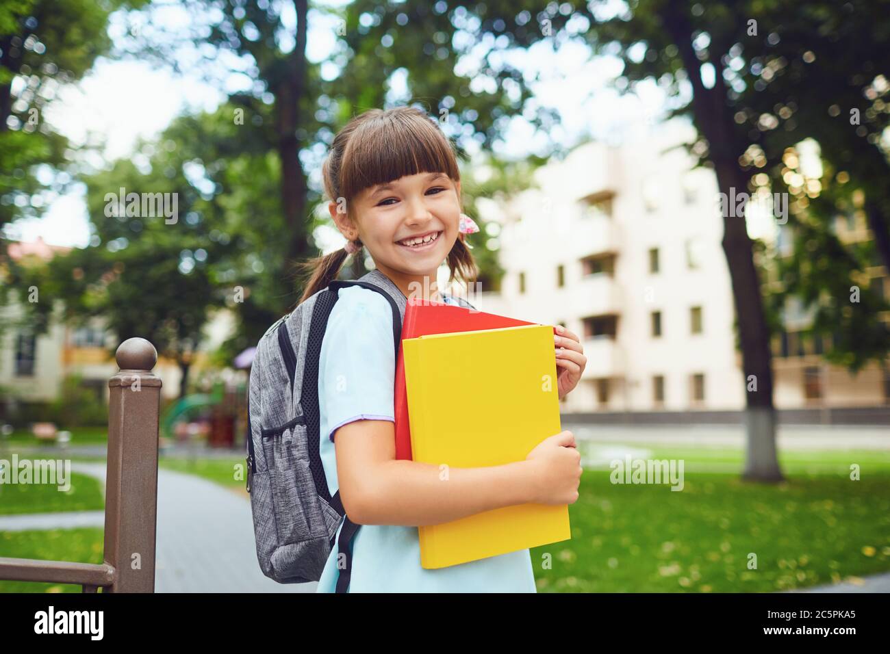 Happy little student girl with a backpack on her way to school Stock ...