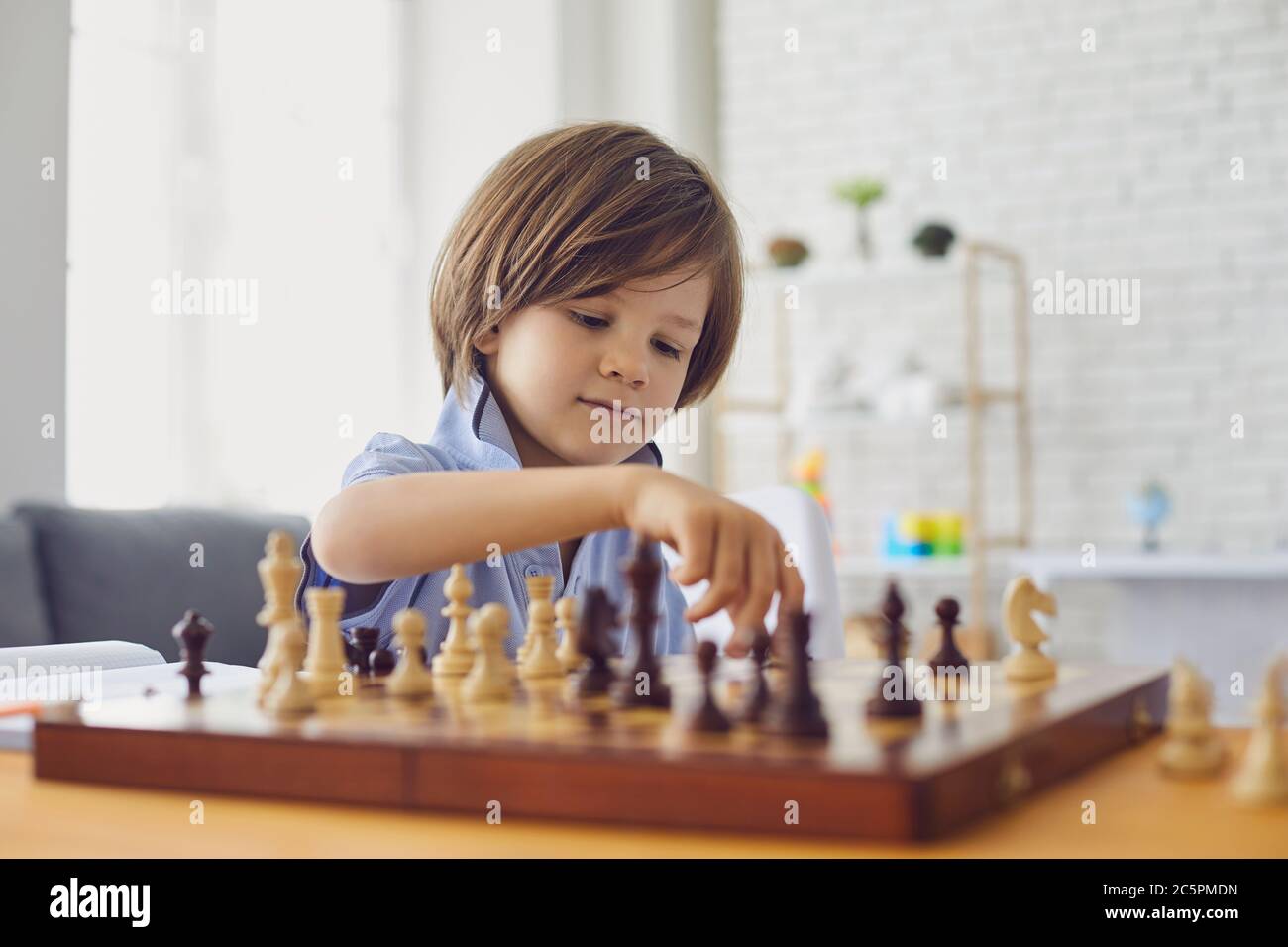 Child boy playing chess hi-res stock photography and images - Alamy