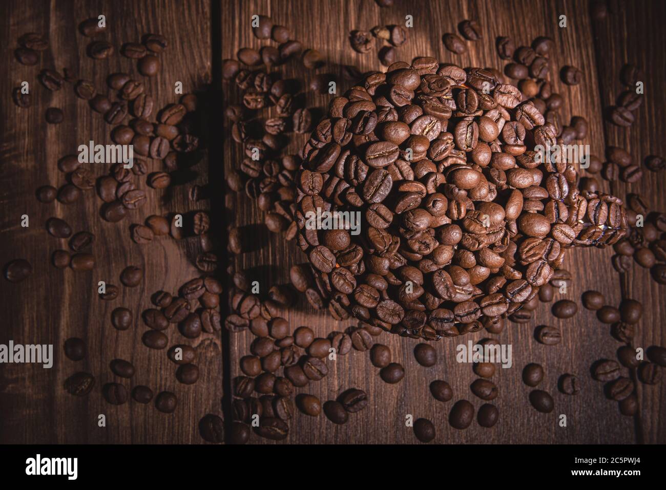 Coffee Cup Table Tree. Сup of coffee wooden table. Full cup of coffee beans on a wooden table. Natural coffee beans arabica. Background for coffee bea Stock Photo