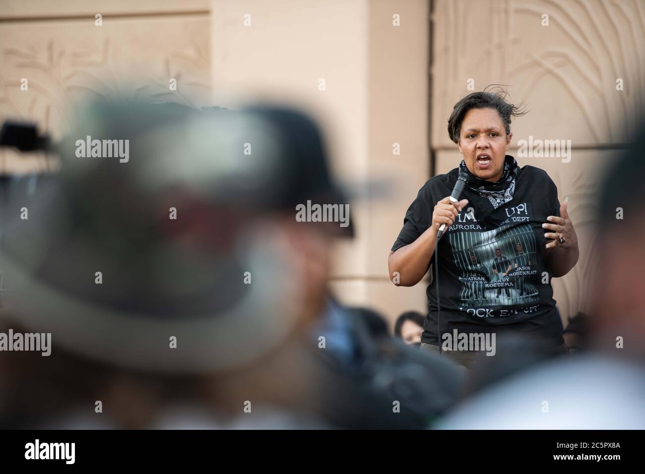 Aurora, Colorado, USA. 3rd July, 2020. McClain family friend, Candace Bailey, pumps up a crowd before a march in Aurora, Colorado on Friday July 3rd, 2020 Credit: Tyler Tomasello/ZUMA Wire/Alamy Live News Stock Photo
