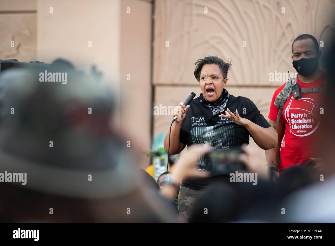Aurora, Colorado, USA. 3rd July, 2020. McClain family friend, Candace Bailey, pumps up a crowd before a march in Aurora, Colorado on Friday July 3rd, 2020 Credit: Tyler Tomasello/ZUMA Wire/Alamy Live News Stock Photo