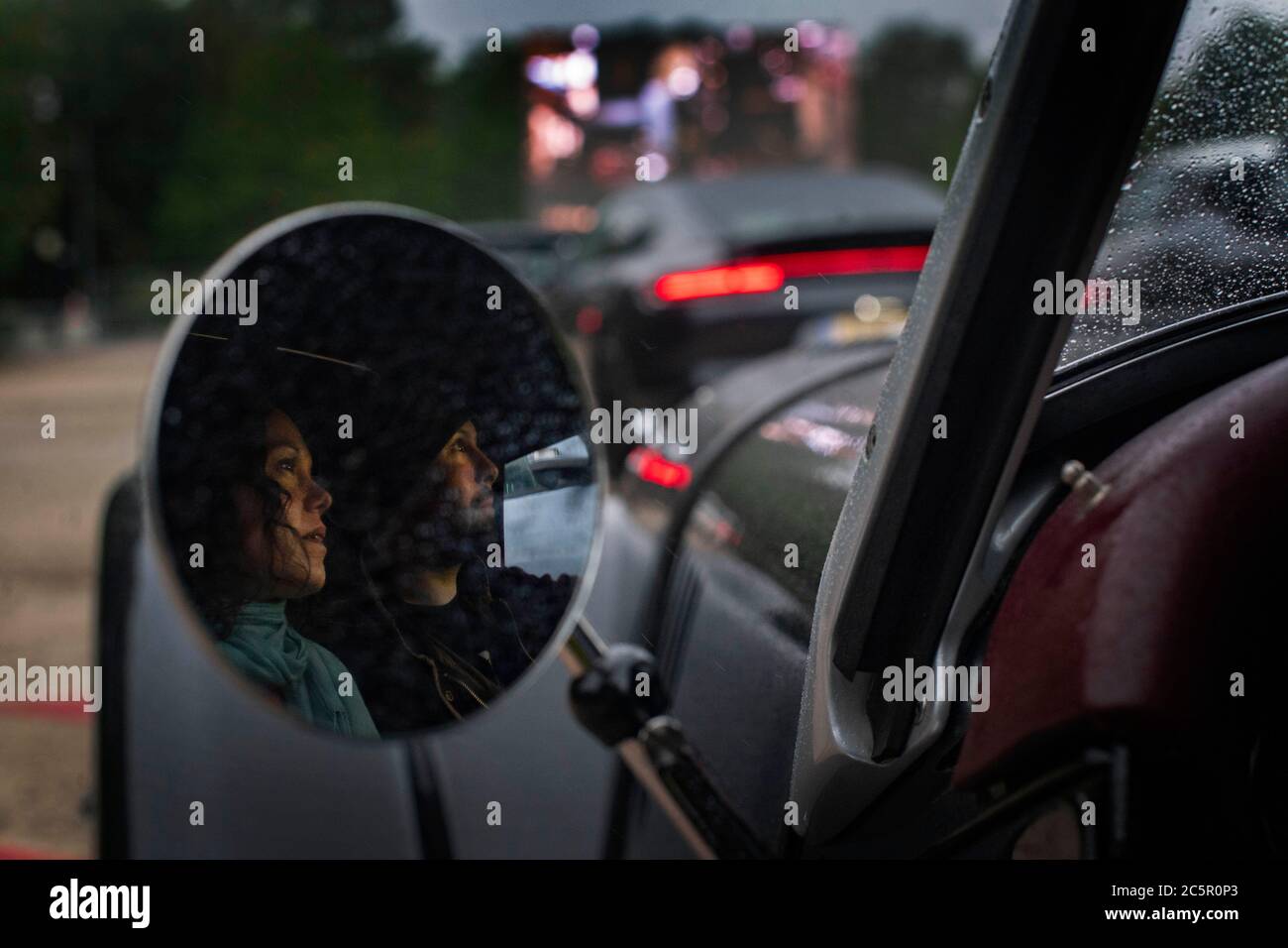 A couple watch a screening of Back to the Future at the Drive in Film Club cinema in Alexandra Palace, London, as coronavirus lockdown restrictions are eased across England. Stock Photo