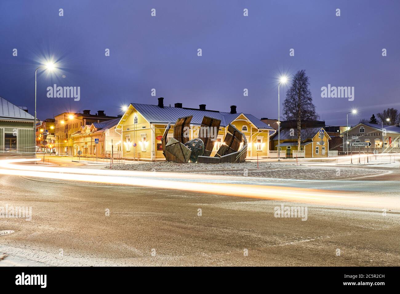 Joensuu, Finland - November 23, 2018: The new roundabout at night with light trails. In the center of the intersection is a modern art object. Old Eur Stock Photo