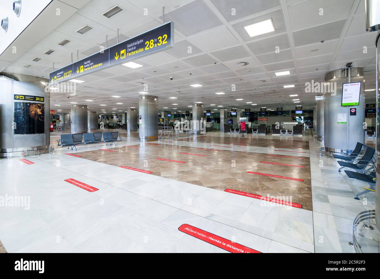 Empty unused terminal, lonuge, check in desks at Tenerife South airport, departures area, due to coronavirus Covid-19 outbreak travel restrictions. Stock Photo