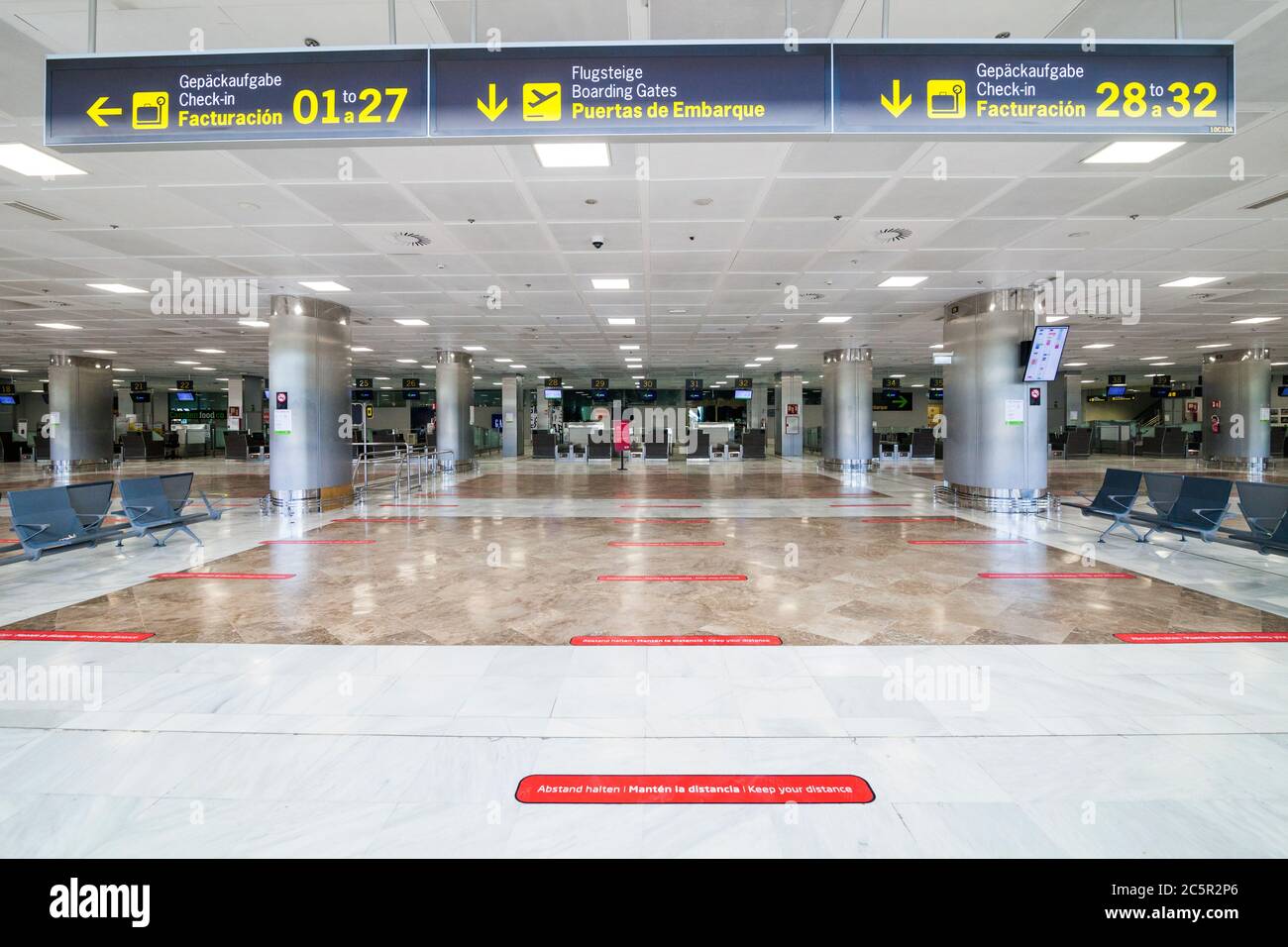 Empty unused terminal, lonuge, check in desks at Tenerife South airport, departures area, due to coronavirus Covid-19 outbreak travel restrictions. Stock Photo