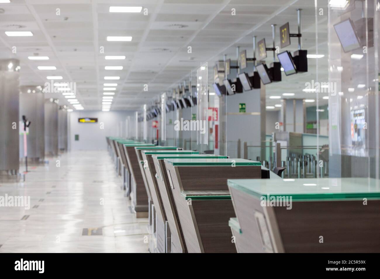 Empty unused terminal, lonuge, check in desks at Tenerife South airport, departures area, due to coronavirus Covid-19 outbreak travel restrictions. Stock Photo