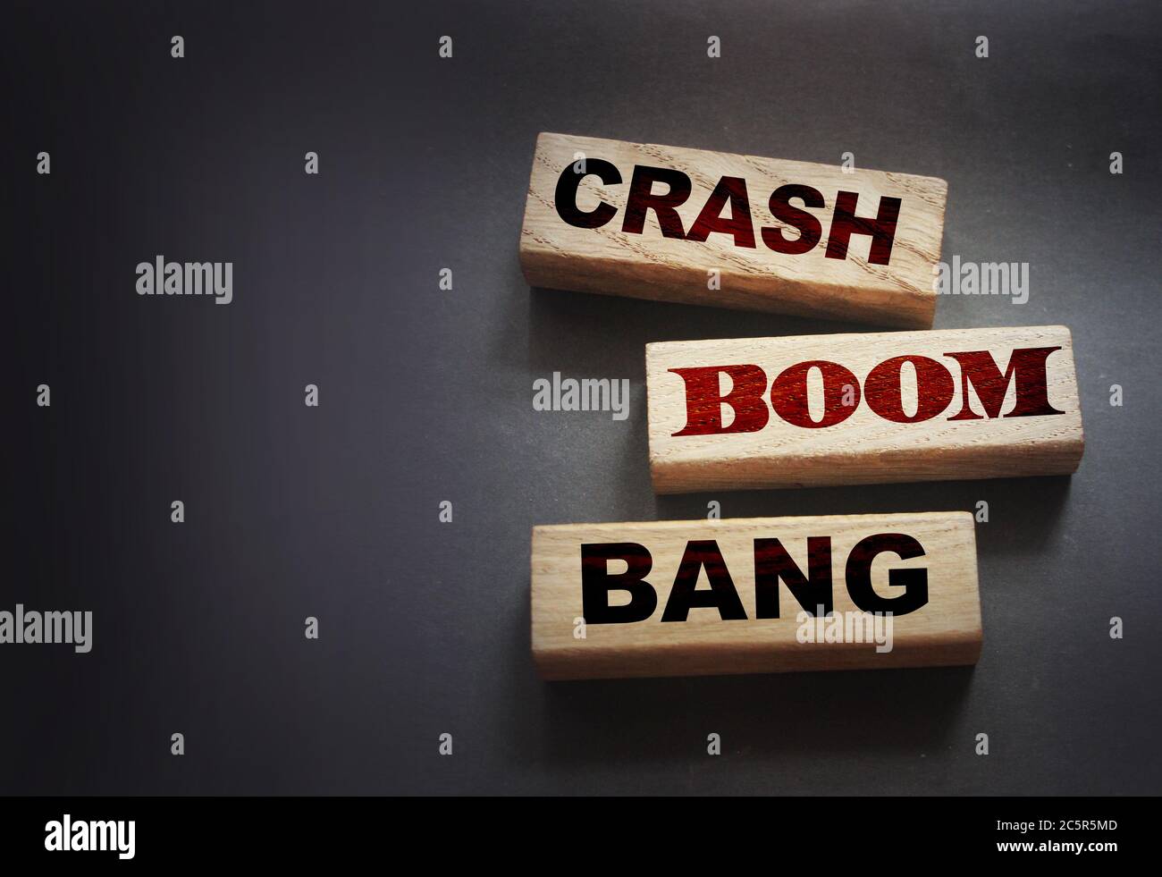 Crash boom bang words on wooden blocks on black. crisis concept Stock Photo