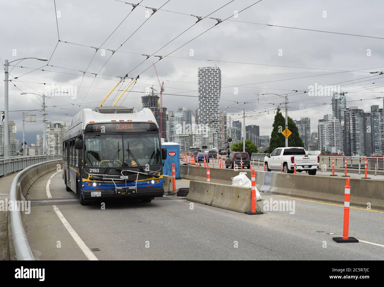 A trolley style transit bus (connected to overhead wires) travels