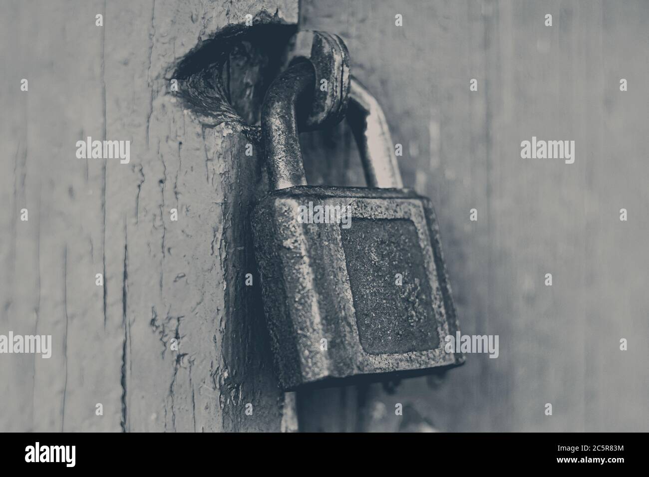Old rusty cast iron padlock on red painted door Stock Photo