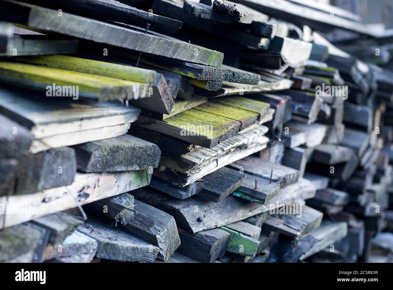 Stacked old boards of disassembled constructions will be used as firewood Stock Photo