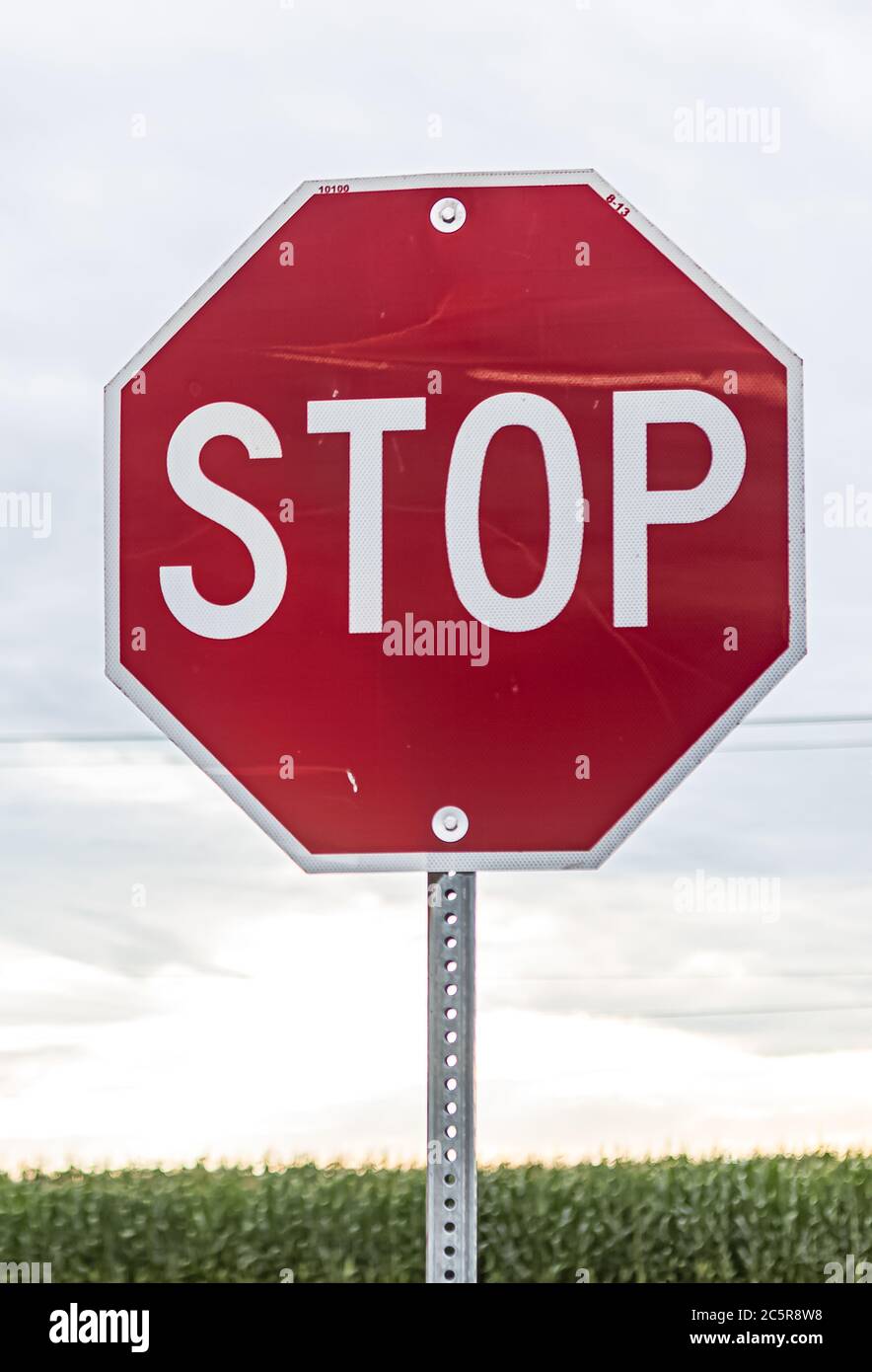 Stop sign for traffic against cloudy sky Stock Photo