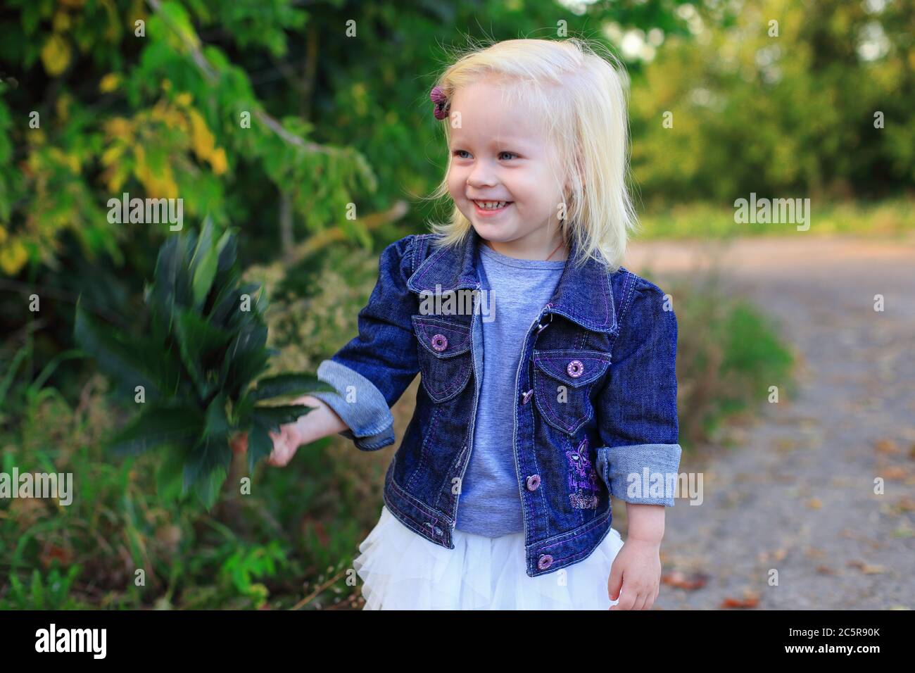 Portrait of a beautiful blonde girl outdoors in summer Stock Photo