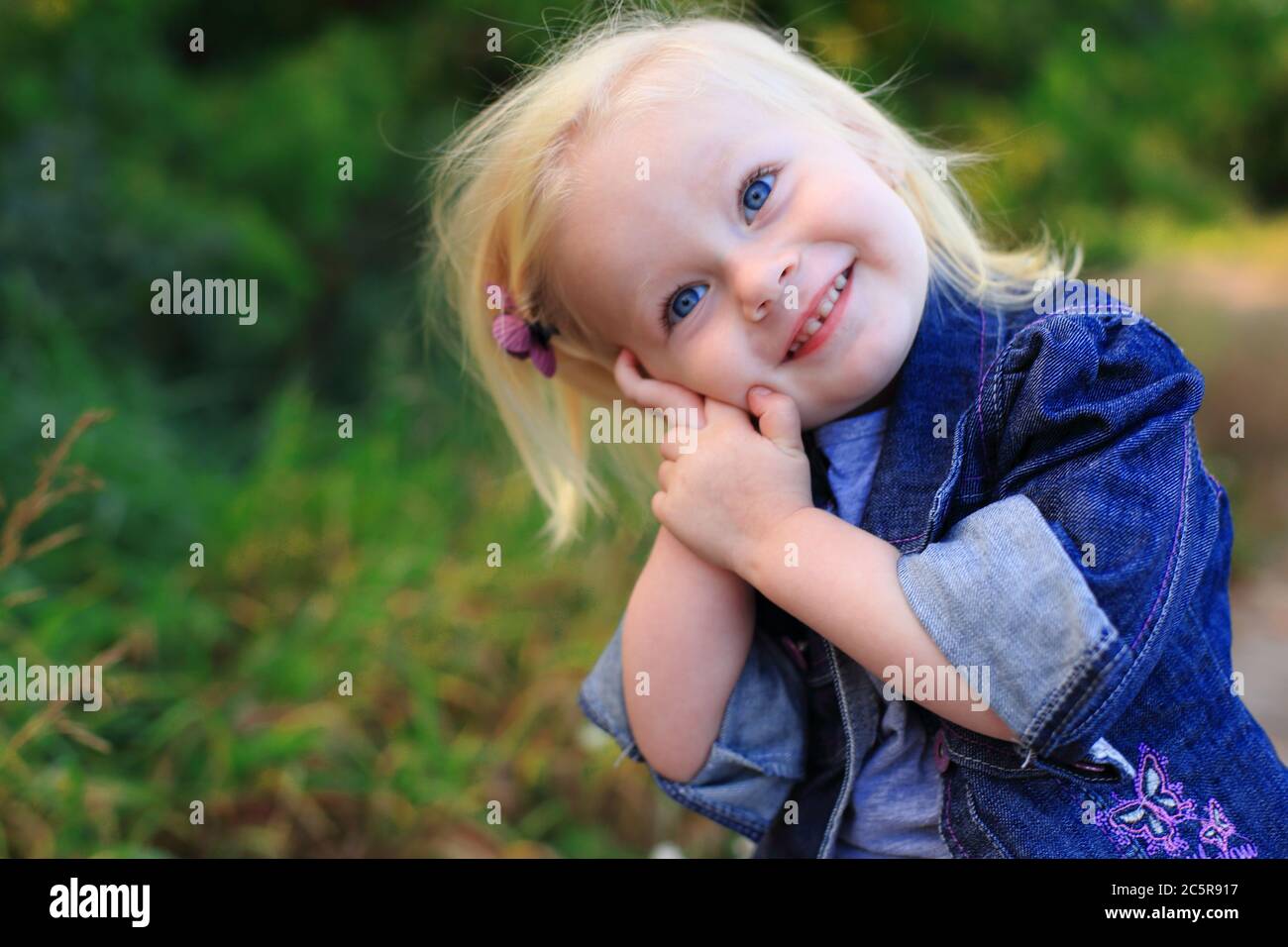 Portrait of a beautiful blonde girl outdoors in summer Stock Photo