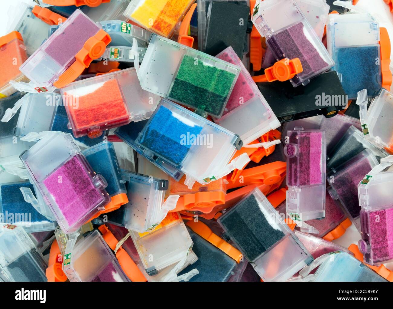 Empty inkjet color cartridges on white background for recycling. Stock Photo