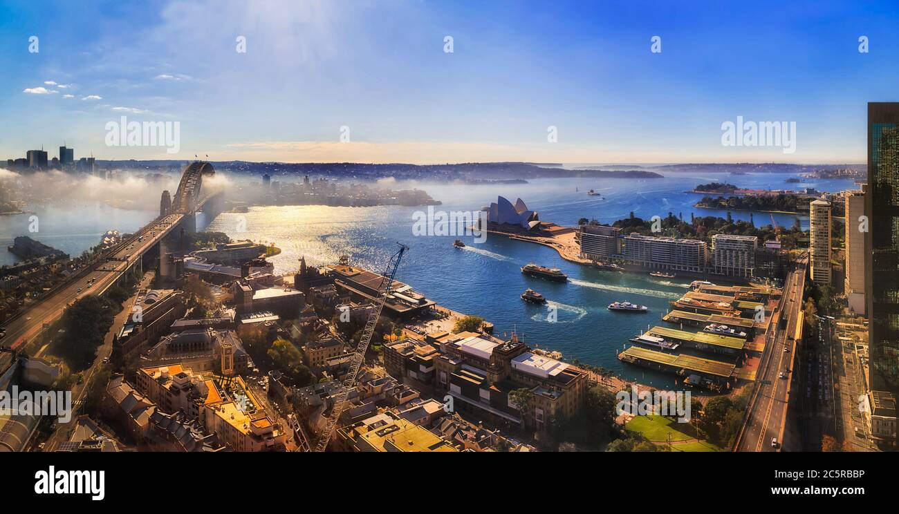Sydney harbour around the Sydney Harbour bridge with The Rocks and Circular quay major city CBD landmarks from altitude of waterfront tower. Stock Photo