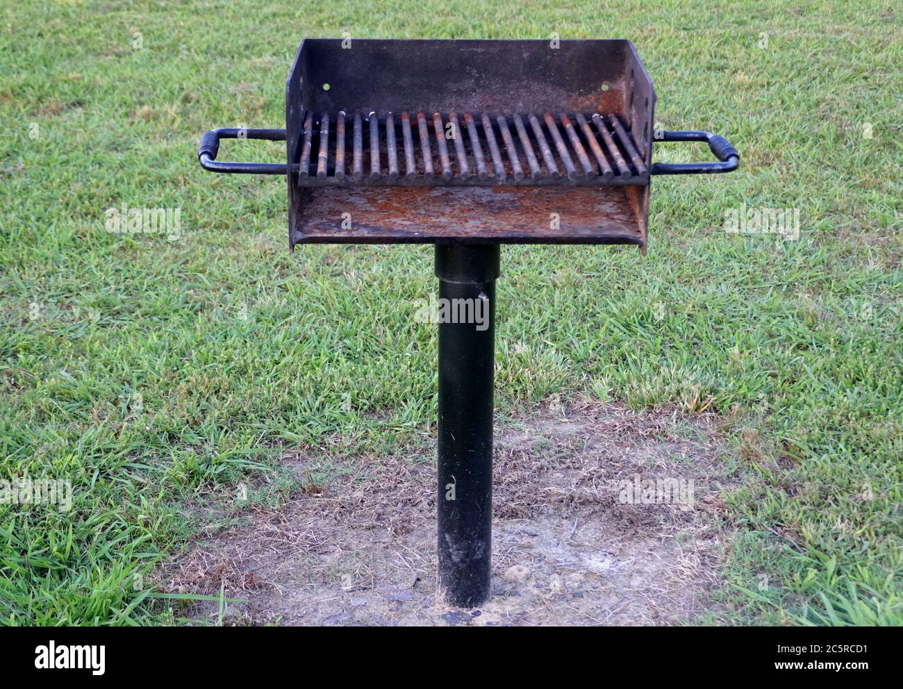 A black charcoal grill installed on the ground Stock Photo Alamy