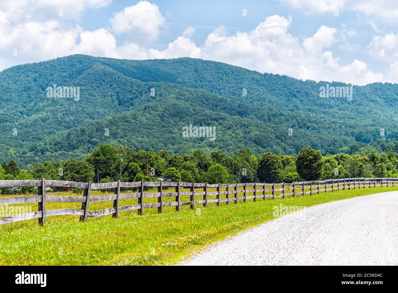 Farm road wooden fence in Roseland, Virginia near Blue Ridge parkway mountains in summer with idyllic rural landscape countryside in Nelson County Stock Photo