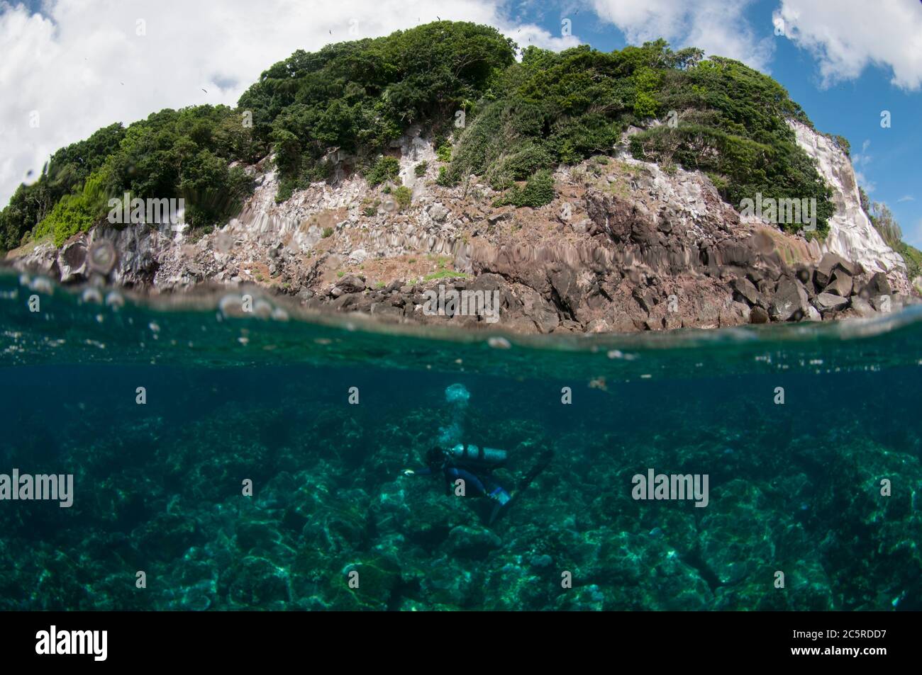 Diver and island split shot, Red Cliff dive site, Manuk Island