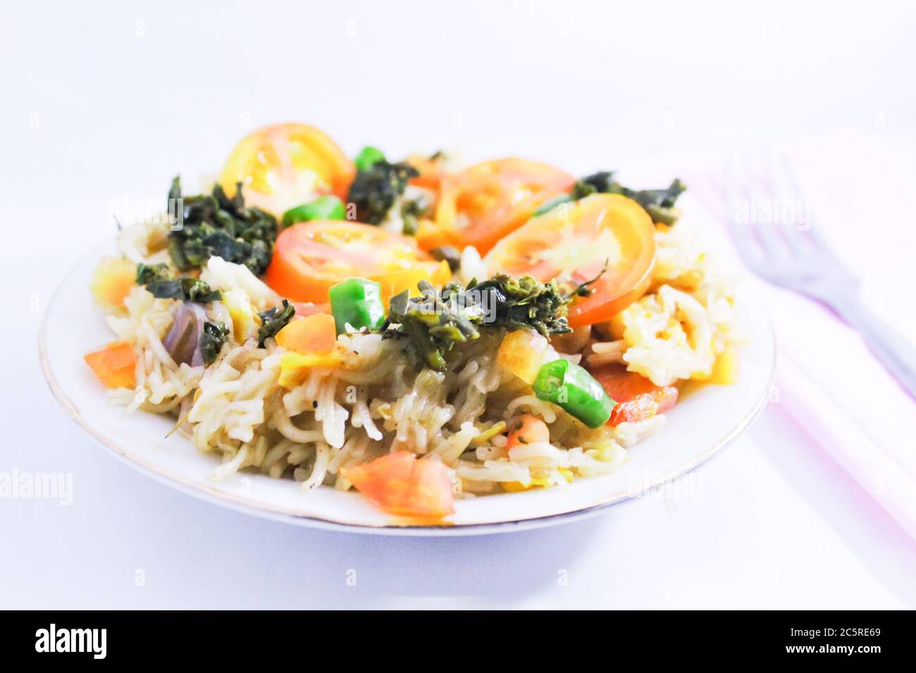 Noodles in a bowl cooked with tomatoes Stock Photo
