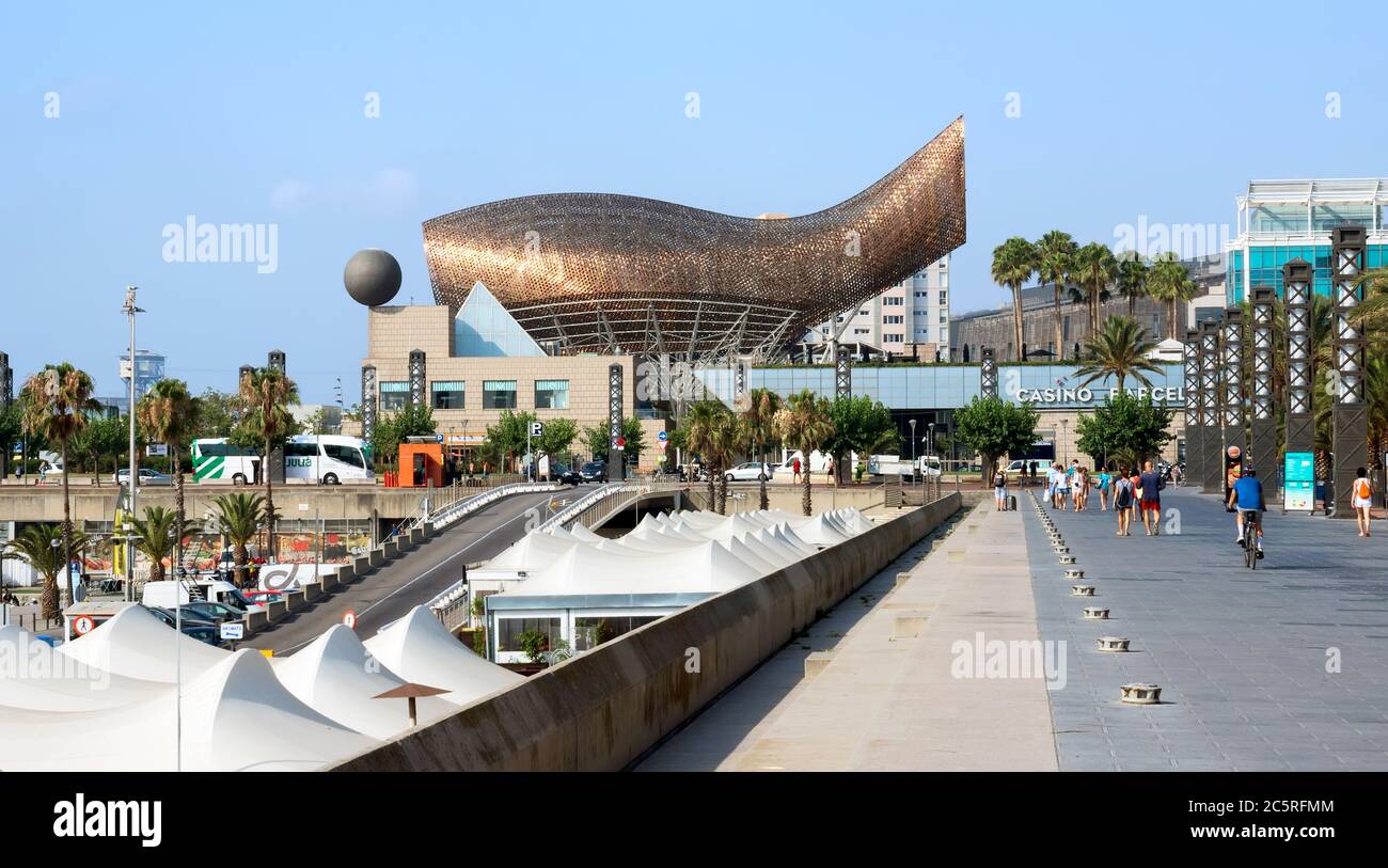 BARCELONA, SPAIN - JULY 12, 2015: Promenade and Frank Gehry's modern El Peix d'Or sculpture is located in Barcelona's Vila Olimpica, Olympic Village f Stock Photo