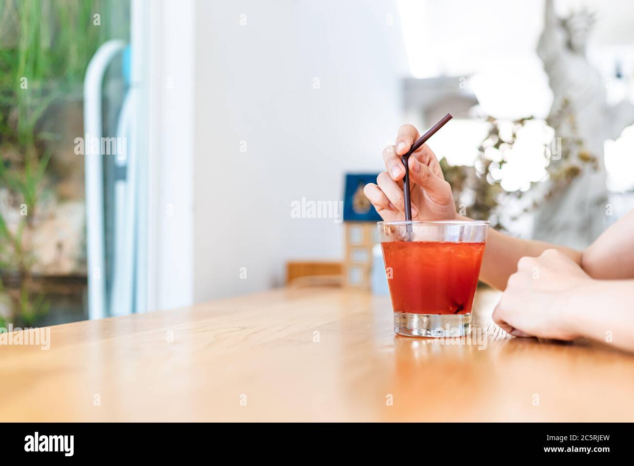 Women drink Juicy strawberry mixed juicy peach. Drink refreshment at sunny day. Stock Photo