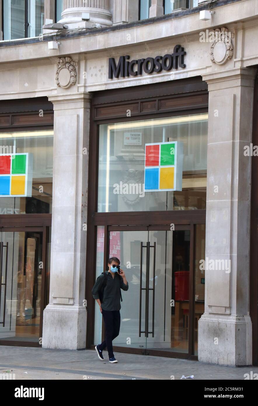 London, UK. 03rd July, 2020. A man walks past the Microsoft store.Microsoft has said it will keep all of its retail locations closed permanently, including London's Flagship store in Oxford Circus which opened just one year ago. The company says it will reimagine some of its spaces that serve its customers, including the Microsoft Experience Centre in London. Credit: SOPA Images Limited/Alamy Live News Stock Photo