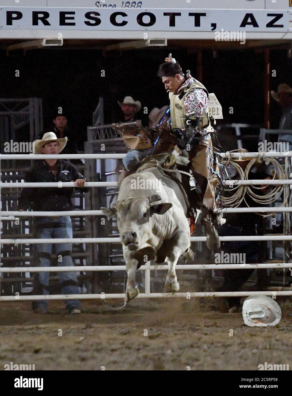 Prescott, AZ, USA. 3rd July, 2020. Jesse Flores, from Valinda, California, competes in the Bull Riding event during the 133rd Prescott Frontier Days Rodeo in Prescott, Arizona Friday July 3, 2020. The rodeo, the longest running in the world, continued on despite the coronavirus pandemic with fan capacity limited to 25 percent at the venue. Credit: Will Lester/ZUMA Wire/Alamy Live News Stock Photo